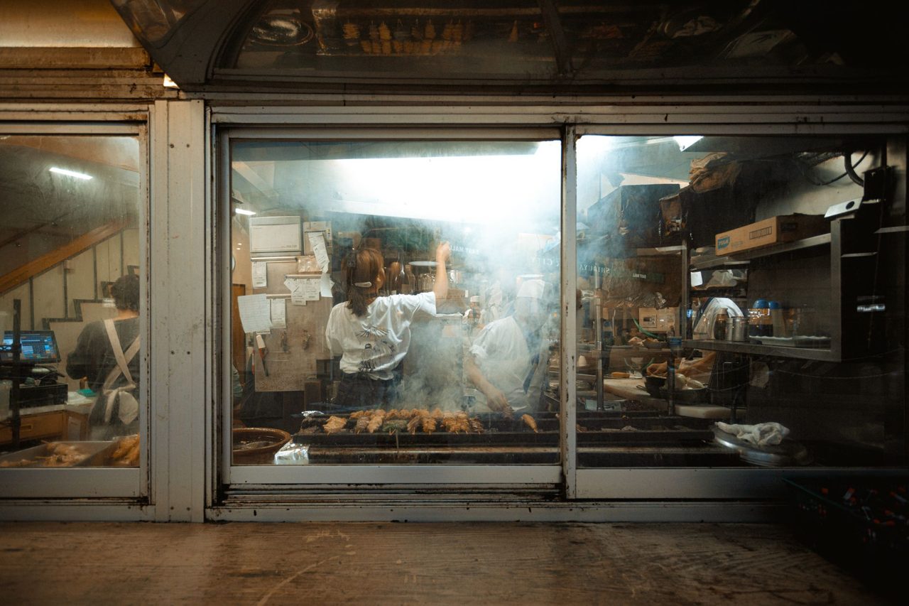 restaurant owner using tablet in kitchen